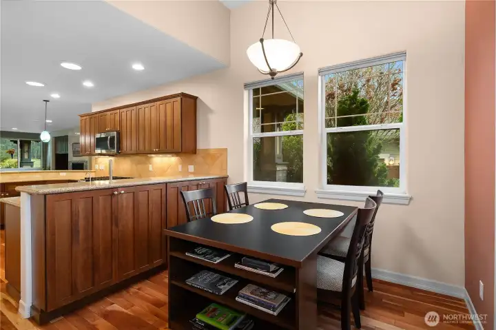 Beautifully updated kitchen featuring quartz countertops, hardwood floors, a new gas oven and range, dishwasher, and microwave. Upgraded cabinetry with pull-out shelves and a charming eat-in space make this kitchen both stylish and functional.