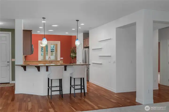 Beautifully updated kitchen featuring quartz countertops, hardwood floors, a new gas oven and range, dishwasher, and microwave. Upgraded cabinetry with pull-out shelves and a charming eat-in space make this kitchen both stylish and functional.