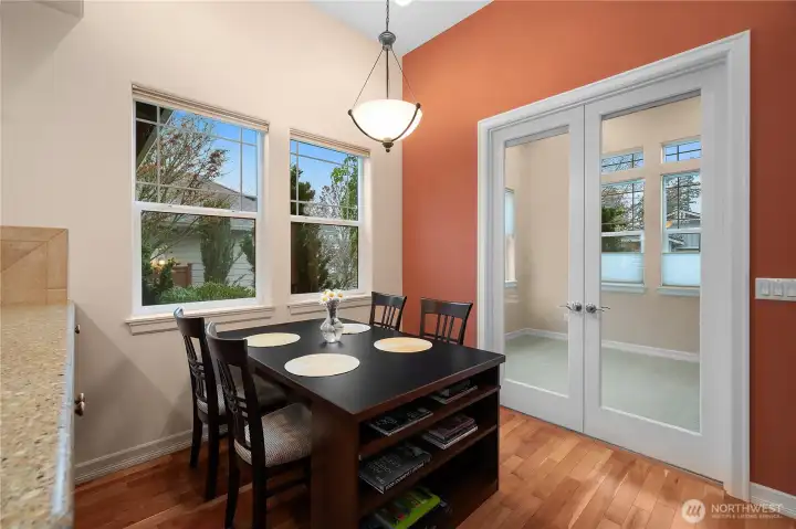 Beautifully updated kitchen featuring quartz countertops, hardwood floors, a new gas oven and range, dishwasher, and microwave. Upgraded cabinetry with pull-out shelves and a charming eat-in space make this kitchen both stylish and functional.