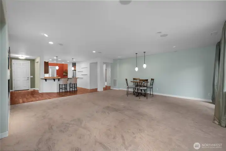 Living room with stunning views of the 12th fairway, new carpet, and a beautifully crafted custom tiled fireplace, an inviting space to relax and take in the scenery.