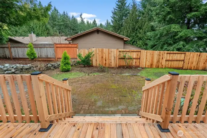 New wrap around deck with stairs down to paver patis