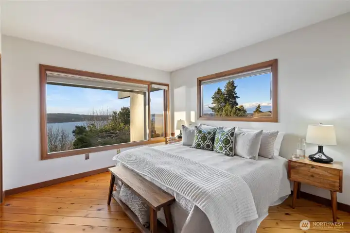 Primary Bedroom with hardwoods and view windows.