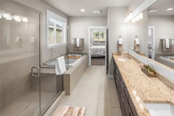 Slab granite vanity with dual sinks, tile floors, a huge walk in shower and designated soaking tub have you feeling like you are in a spa.