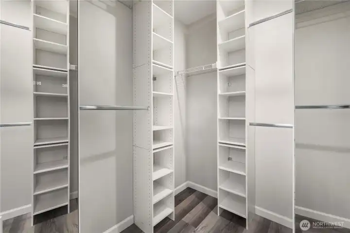 Primary walk-in closet with organizers.