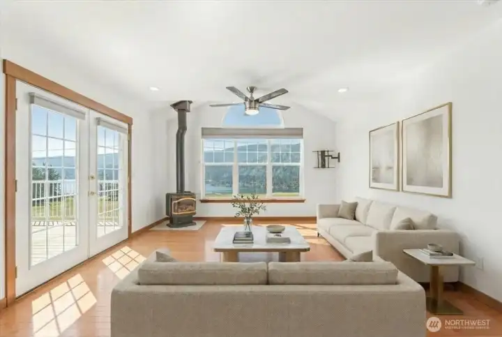 Virtually Staged Upstairs family room with french doors out to the deck