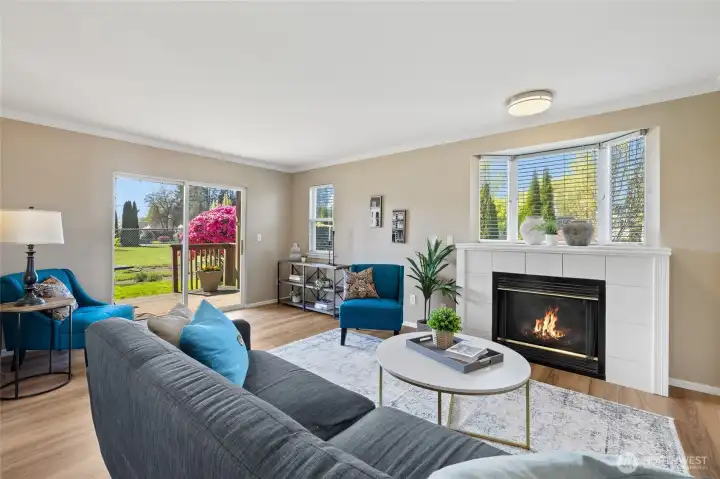 Very spacious living room; beautiful floors, loads of natural light & a cozy fireplace.