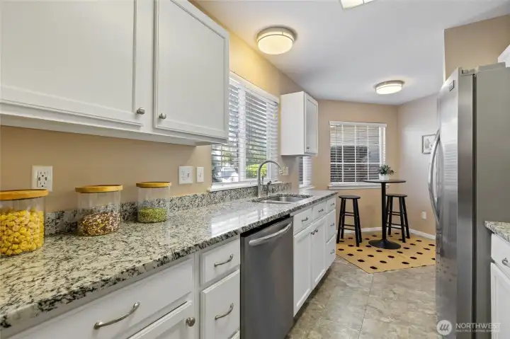 Beautiful white cabinetry and lovely granite countertops.