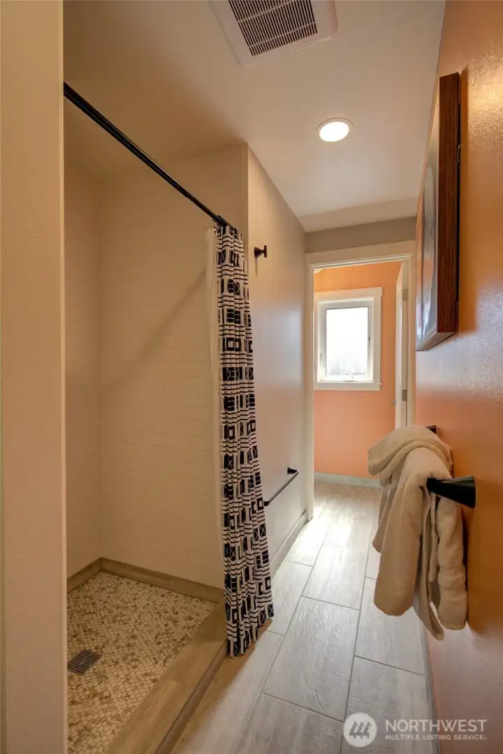 Main bath with beautiful tilework.