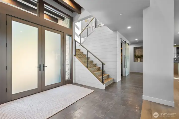 The soaring vaulted entry is bathed in natural light, creating an immediate sense of openness and grandeur.