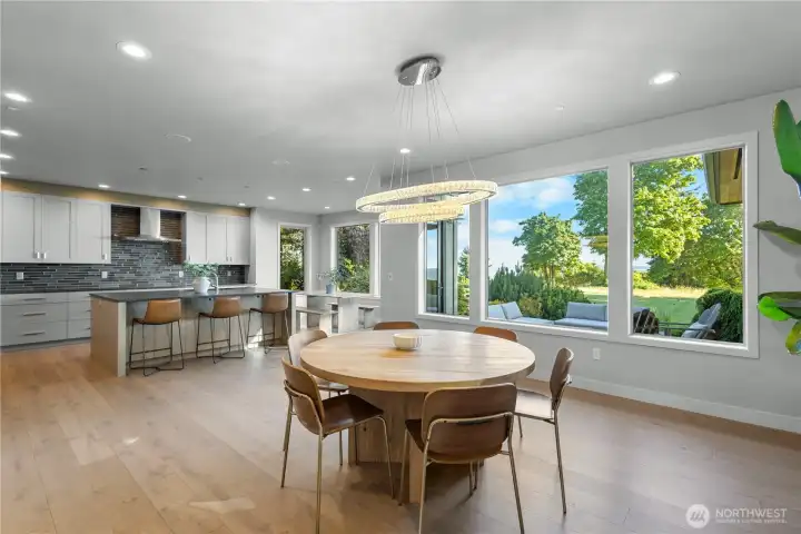 Expansive windows frame the lush outdoor scenery, providing a stunning natural backdrop for every meal.