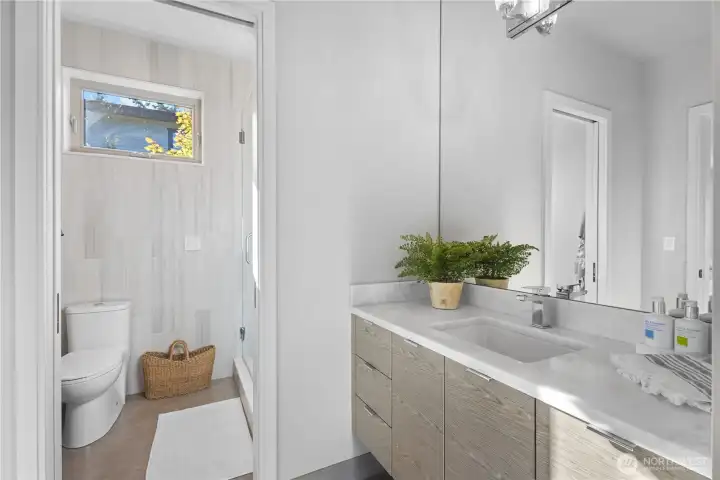 The same premium finishes found throughout the upper levels are mirrored here, featuring custom tile work and designer fixtures.