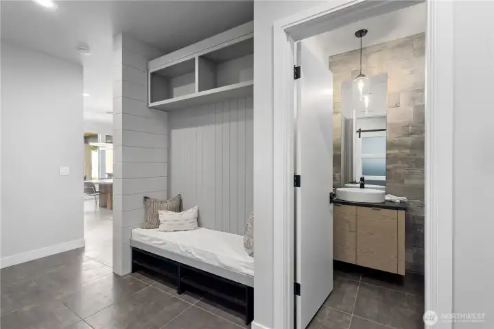 The same level of craftsmanship found in the kitchen extends here, with premium finishes that make even a utility space feel like a destination.