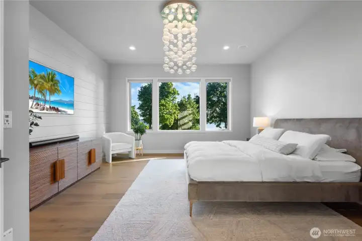 A serene and sun-drenched primary bedroom designed for total relaxation, featuring a crisp, neutral palette and voluminous ceilings.