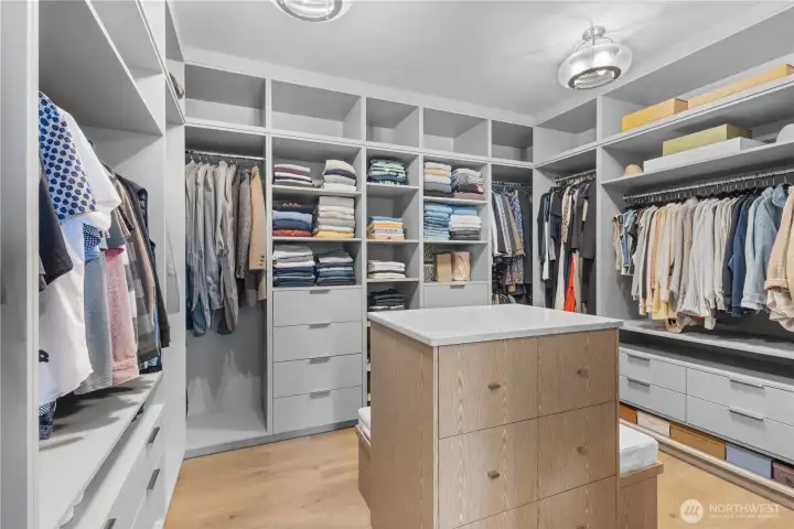 A sprawling, boutique-inspired walk-in closet that offers incredible scale and a masterclass in high-end organization.