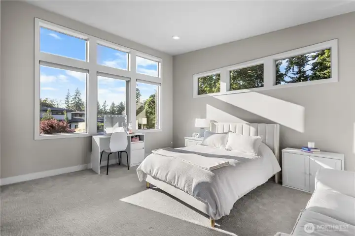 Wake up to a bright and cheerful atmosphere in a room designed to maximize natural light and capture peaceful views in this en-suite bedroom!