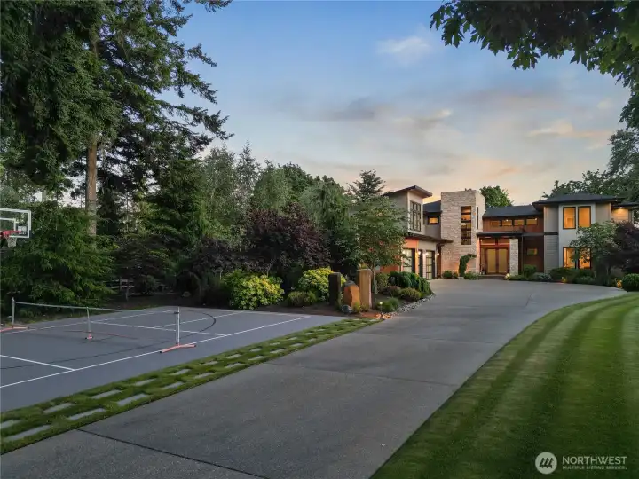 Tucked perfectly to the side of the grand entrance, this private sports court offers a professional-grade space for basketball, pickleball, or tennis.