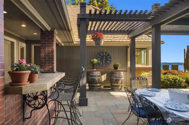 From the main kitchen one accesses to the entertaining area with its built-in outdoor kitchen.