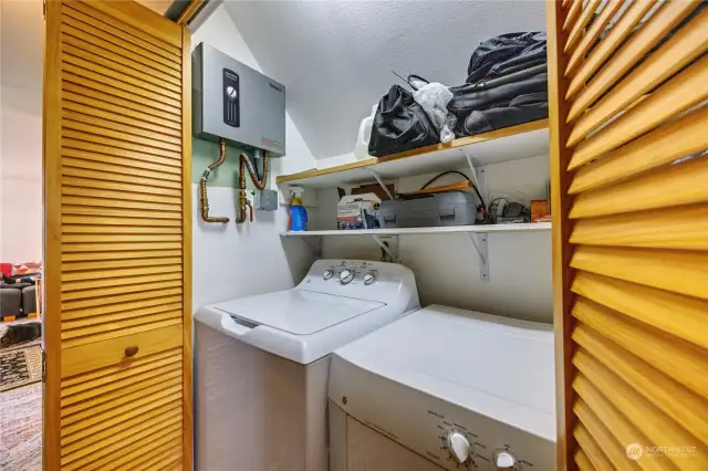 Laundry in the hall closet with the demand hot water panel.