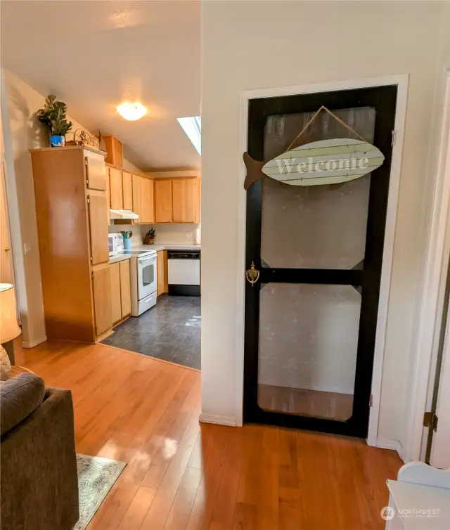 East facing entry way into open concept living room and kitchen.