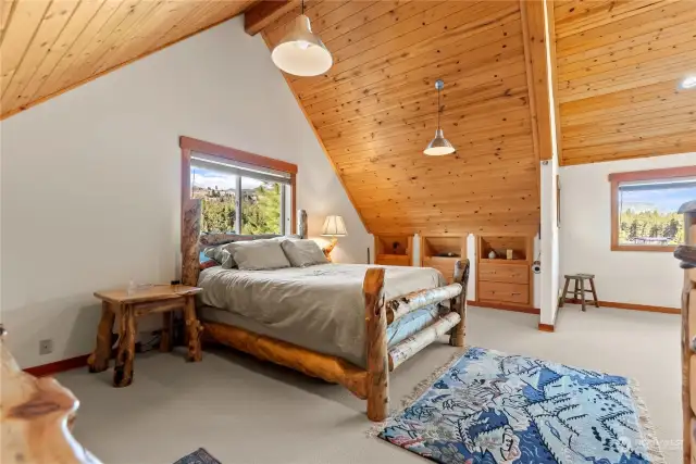 Loft Bedroom enjoys wall to wall carpeting, built in dressers, Wood ceilings with big timber features. Great views and natural light.