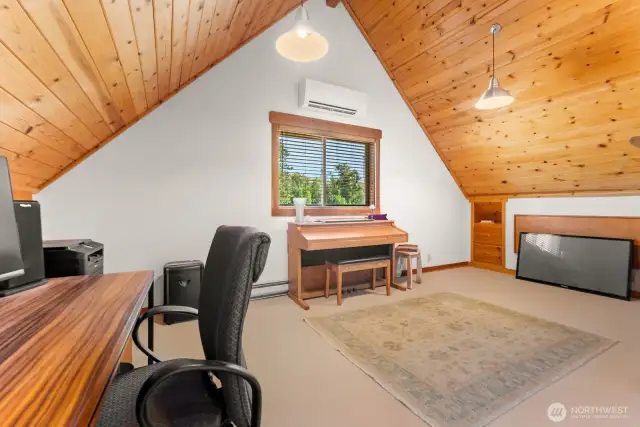 Upper level of home extra Guest room is carpeted. Heat and cooling system with A/C Mini split and electric heat. Nice bedroom. Quiet and privacy complete. Currently office and den with piano.