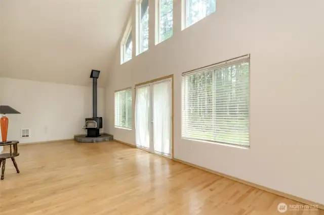 Living room.  Doors open to deck on front which needs repair.