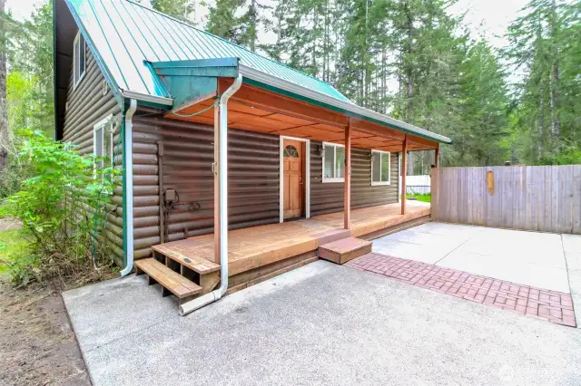 Entry side of home w/concrete patio between home & garage