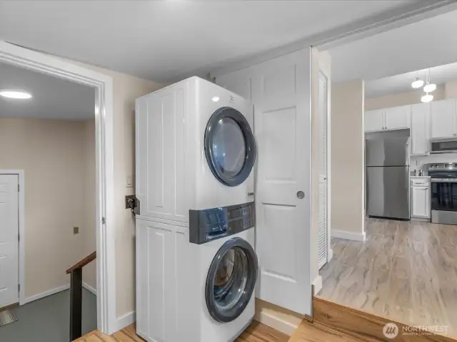 Utility room with pocket door into kitchen and stairs down to mud/storage room