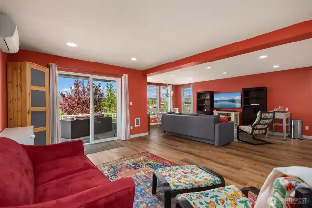 The lower level bonus room has a kitchenette and ample space for large get togethers. The patio and garden await just through the sliding doors.