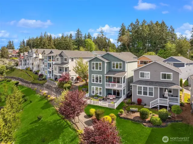 The west side of the home features a deck, sunny patio, and a fenced-in garden area.