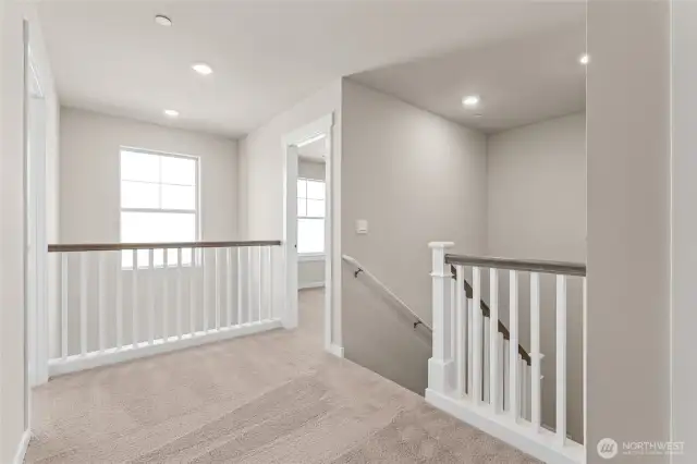 Open railing and vaulted ceiling at the entry of the home standard. Home is under construction and finishes, features, and colors may vary. See site agent for details.