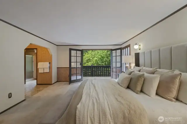 The french doors in the primary suite open up to a charming balcony and welcomes in the lush green surroundings. Leave open and listen to the birds sing. There's so much privacy!