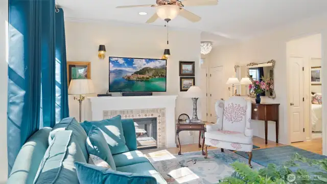 Crystal fixture at entry, ceiling fan and double-sided gas fireplace