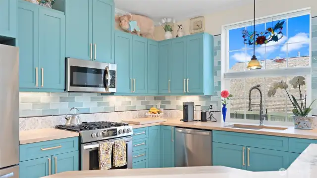 Freshly painted custom cabinetry and handles and custom tile backsplash