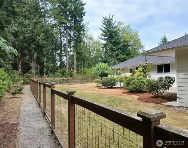 Fully fenced and updated landscaping creates the perfect backyard retreat.