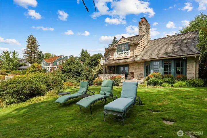 French doors and windows that flood the home with natural light while framing sweeping views of the lake and gardens.