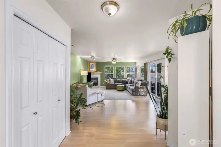 Entry way with large coat closet looking towards the spacious living room.
