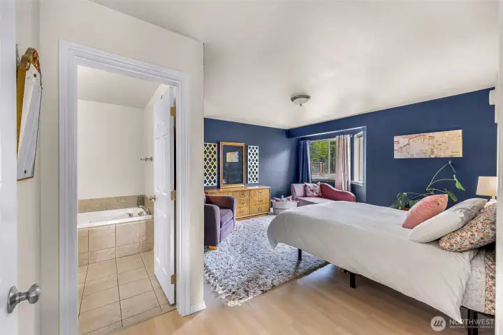 Oversized primary suite with walk in closet off to the left and ensuite bathroom.