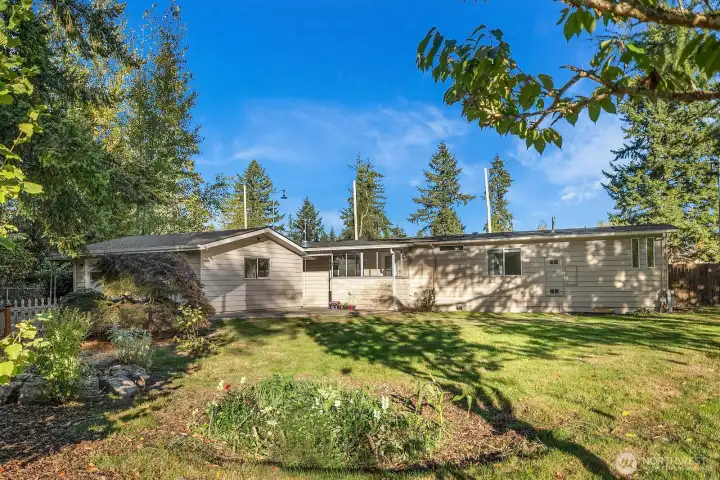 Fantastic level, fenced yard with mature landscaping