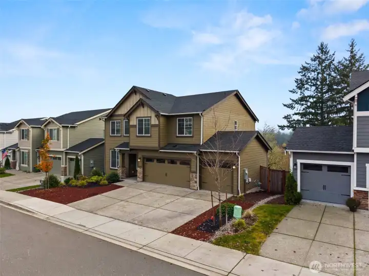 Huge 3-car garage plus driveway parking, on a paved quiet street with sidewalks.