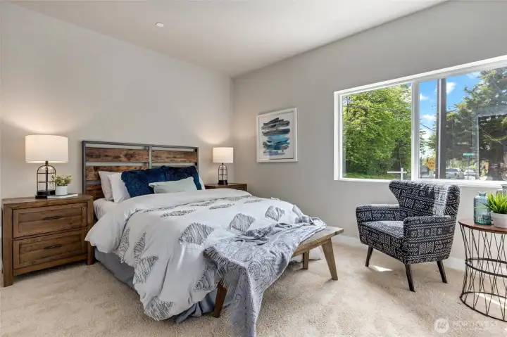 Ideal for guests - Ensuite Bedroom on main level of home with walk-in closet and lighting.