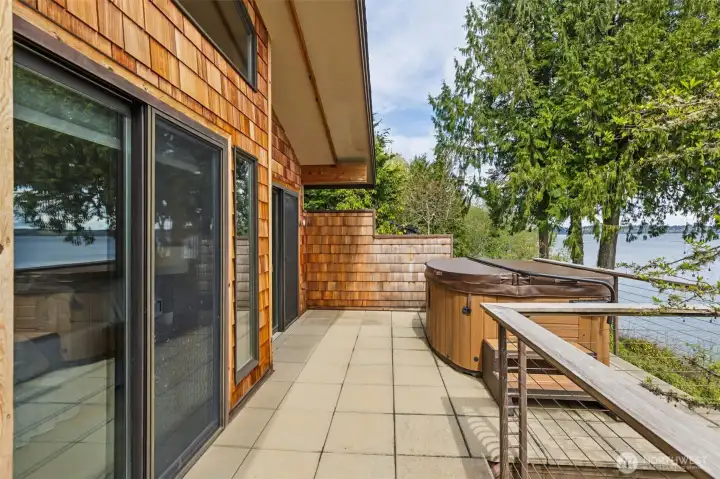 Step outside the primary suite to a private deck with hot tub overlooking incredible views of Budd Inlet & Mt. Rainier