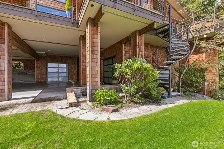 Covered car parking and driveway pad at the bottom of the drive.  Oversized 2 car garage, plus 3rd bay that is great additional storage