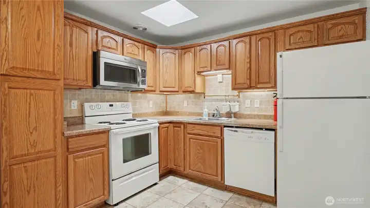 Functional layout with an eat-in kitchen featuring granite countertops, tile flooring, and abundant cabinetry.