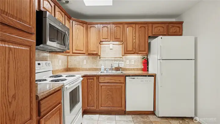 Kitchen also offers white matching appliances.
