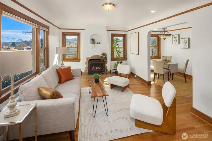 Gorgeous living room and eating nook, with newly finished oak hardwood floor and a inviting wood fireplace, with sweeping views of Cascades, Mt Rainier, the Ship Canal bridge and surrounding areas