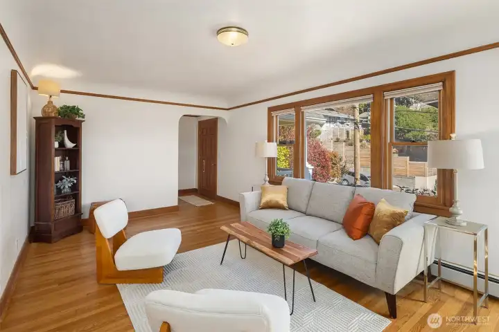 Gorgeous living room with newly finished oak hardwood floor and a inviting wood fireplace