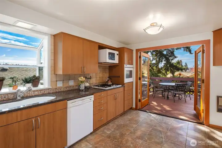 Gorgeous French doors leading to the large deck off the kitchen