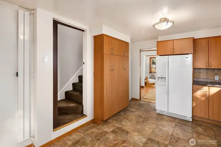 Large kitchen pantry and access to the primary suite upstairs