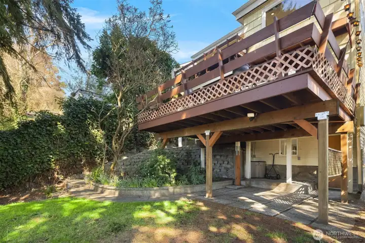 The house as views from the backyard with its two decks and access to the daylight basement